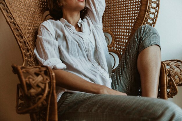 Premium Photo Woman Relaxing On A Vintage Wicker Chair