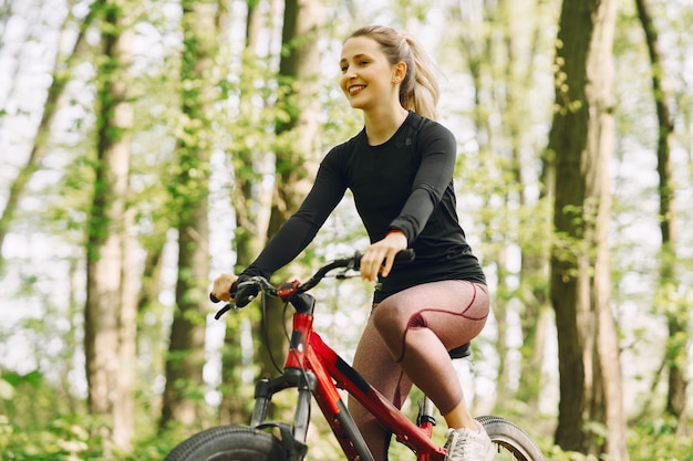 Woman riding a mountain bike in the forest Free Photo