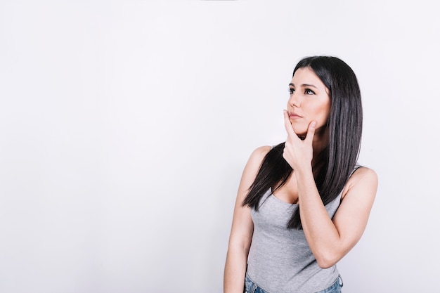 Woman rubbing chin and thinking Photo | Free Download