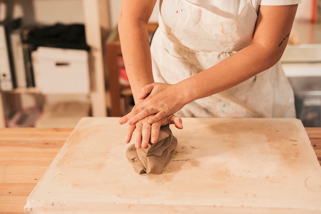 free-photo-woman-s-hand-kneading-a-clay-on-the-table