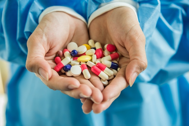 Free Photo | Woman's hand pours the medicine pills out of the bottle