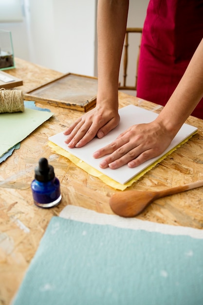 Free Photo | Woman's hand pressing mold for making paper