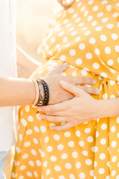 Premium Photo Womans And Mans Hands Hug Pregnant Belly 
