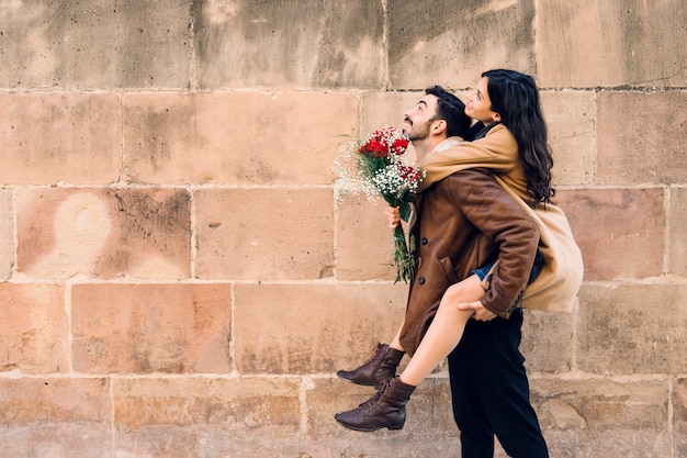 Woman sitting on back of man Free Photo