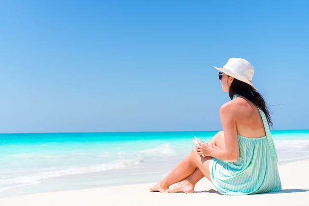 Premium Photo | Woman sitting on beach enjoying summer holidays