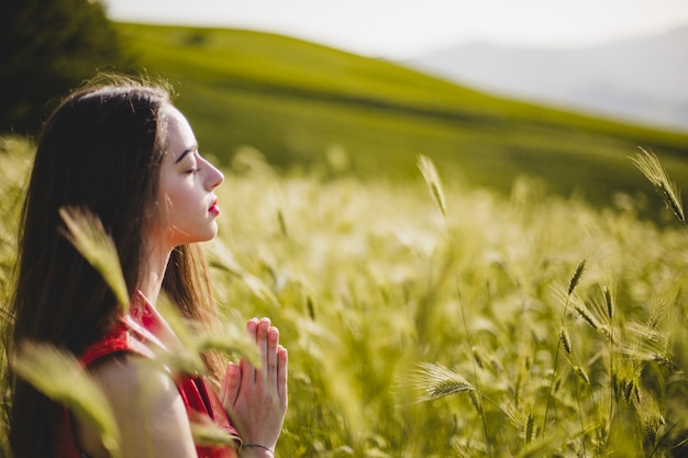 Woman sitting in nature and meditating Free Photo