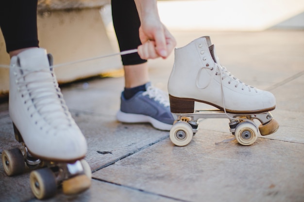 Free Photo | Woman sitting lacing roller skates