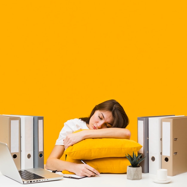 Woman Sleeping On Pillows On Top Of Her Desk Free Photo