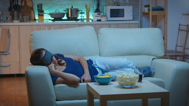 Premium Photo Woman Sleeping With Sleep Mask In Living Room During Tv Show Tired Exhausted Lonely Sleepy Lady In Pajamas Falling Asleep On Cozy Sofa In Front Television Closing Eyes While