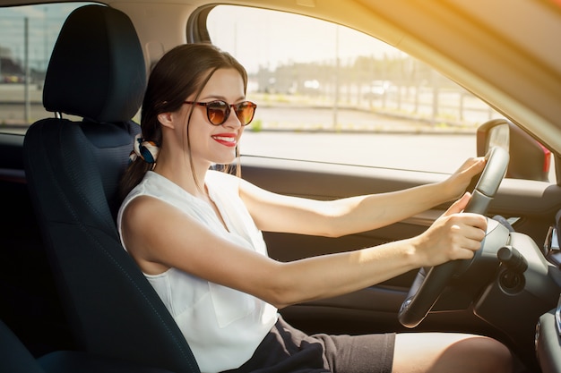 Premium Photo | Woman smiling while driving a car