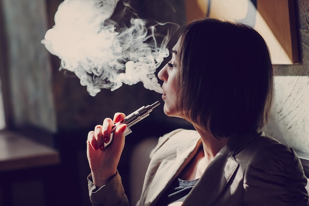 Woman smoking vapor Free Photo