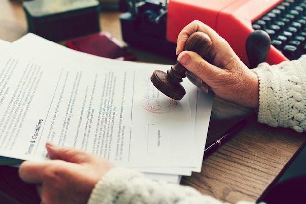 Premium Photo Woman Stamping An Official Document