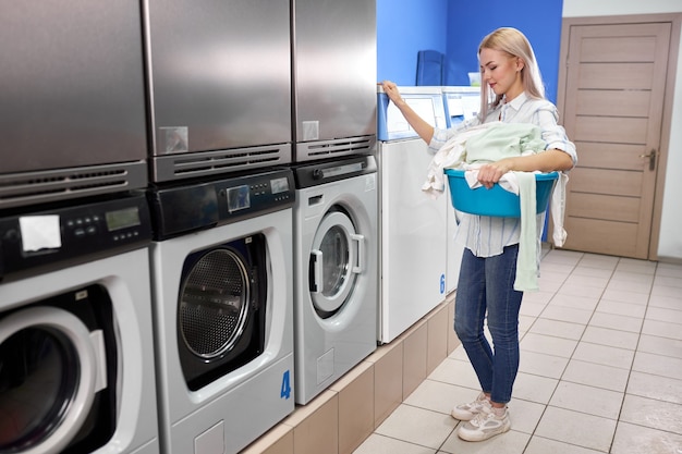 Premium Photo | Woman standing alone with dirty clothes in the self ...