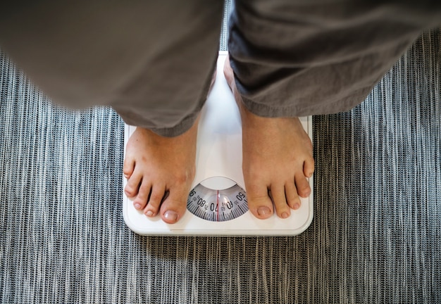 Woman standing on a scale Free Photo