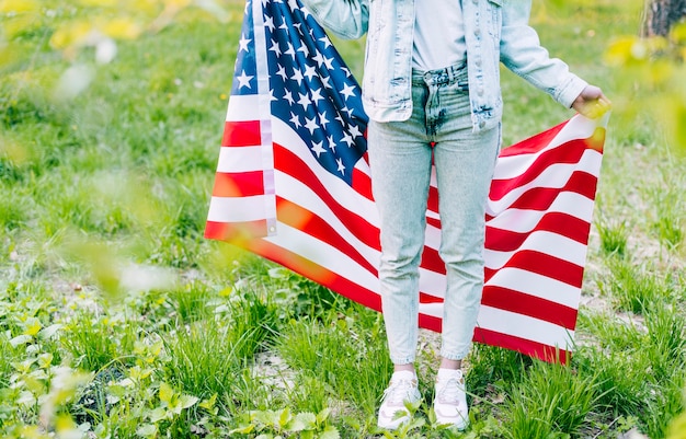 Woman standing with american flag Free Photo