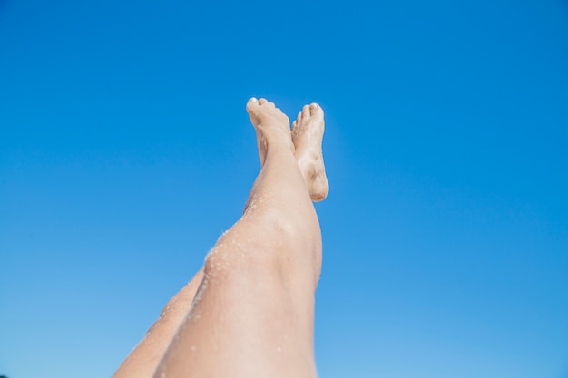 Free Photo | Woman stretching legs towards the sky