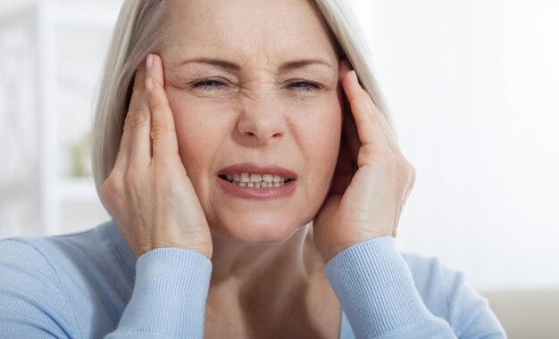 Premium Photo Woman Suffering From Stress Or A Headache Grimacing In