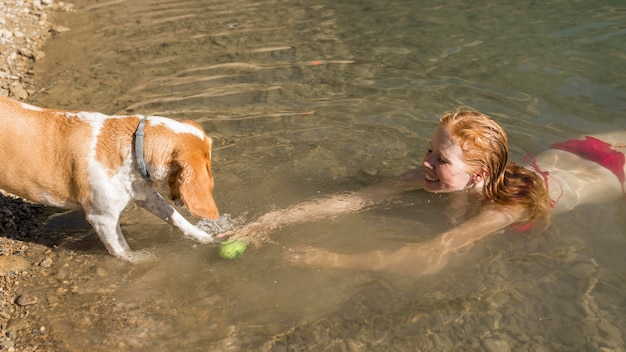 Free Photo | Woman swimming and playing with dog high view