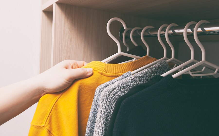 Premium Photo | Woman takes the clothes from the wardrobe