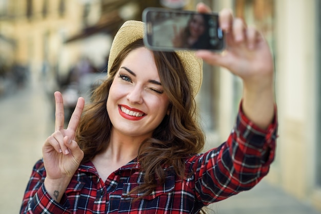 Woman taking a selfie Photo | Free Download