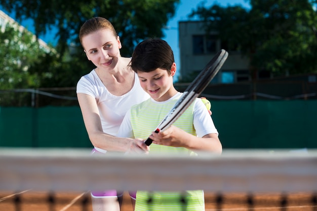 Free Photo Woman Teachekid How To Play Tennis