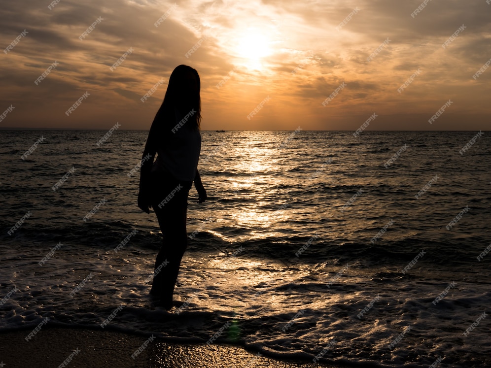 Free Photo | Woman tourist looking at sunset at sea. relaxation at the sea