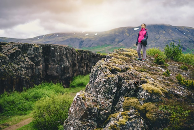 Premium Photo | Woman traveler hiking across iceland landscape.