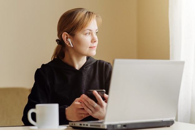 Free Photo | Woman using laptop and mobile phone for his remote work at home