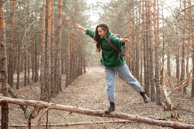 倒れた木の上を歩く女性 無料の写真