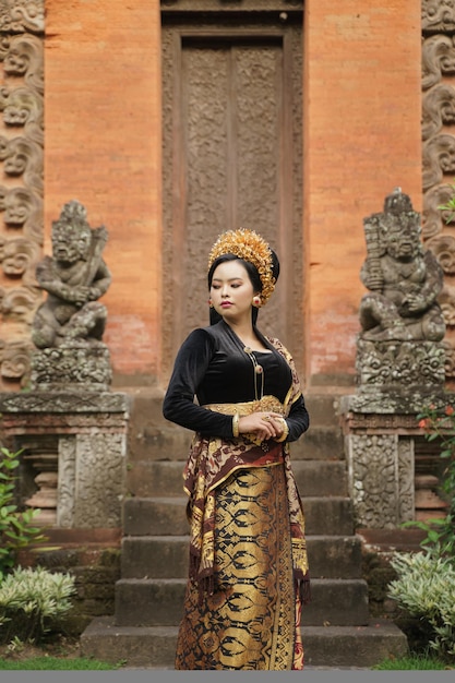 Premium Photo Woman Wearing Balinese Kebaya Looking Side Against Temple