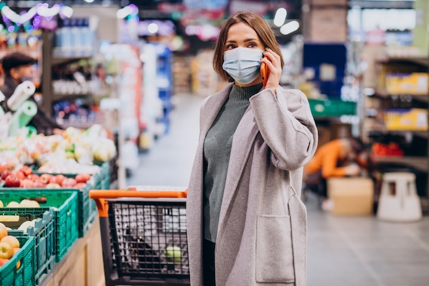 Free Photo | Woman wearing face mask and shopping in grocery store