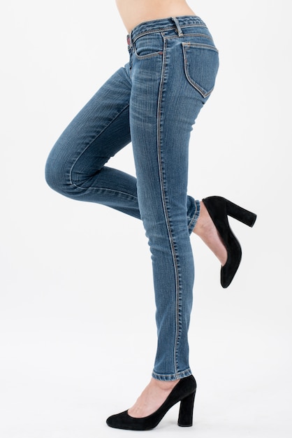 Premium Photo | Woman wearing jeans posing lift her leg in side view ...
