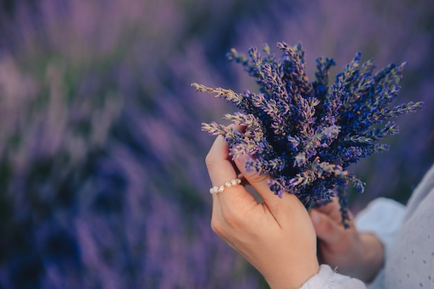 Premium Photo | Woman in white dress holding bouquet of lavender ...