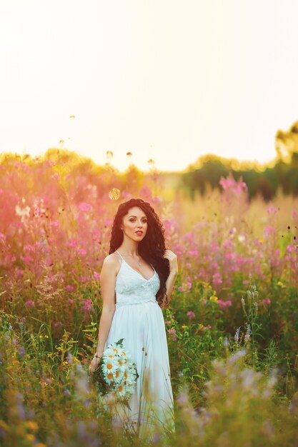 Premium Photo Woman In A White Dress Posing In A Field 3060