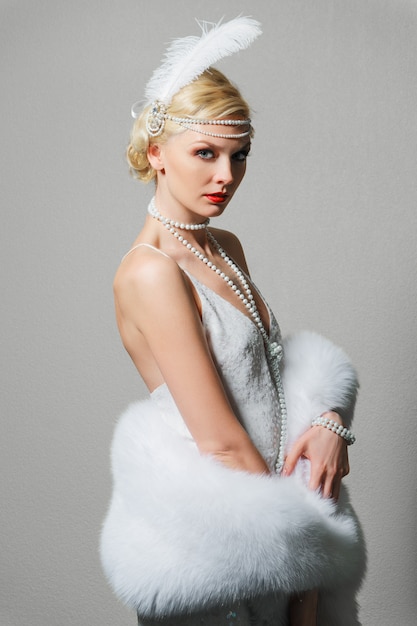 Premium Photo | Woman in white dress with shoulder straps and long fur boa