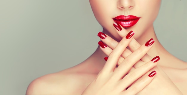 Premium Photo Woman With Bright Red Manicure On The Nails And Well Shaped Red Lips See your favorite lips kiss and tattooed lip discounted & on sale. freepik