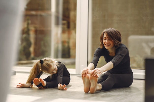 Woman with daughter is engaged in gymnastics Free Photo