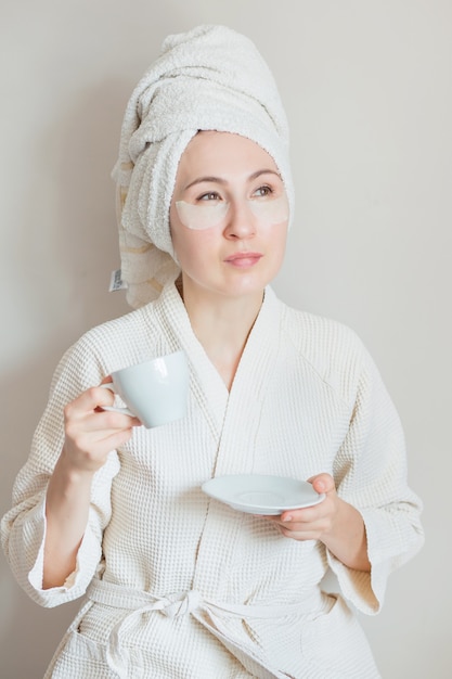 Premium Photo Woman With Face Mask In Bathrobe And Towel On Her Head