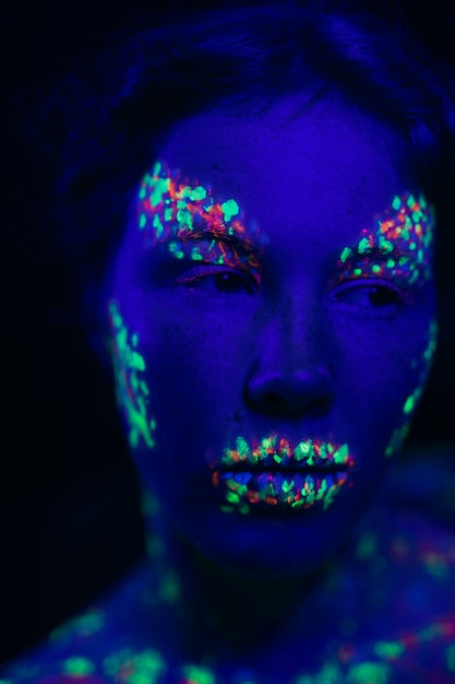 Free Photo | Woman with fluorescent make-up looking away