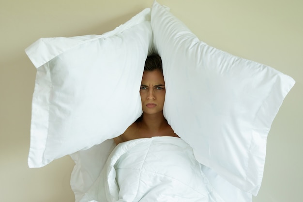 Premium Photo | Woman with pillows on her head