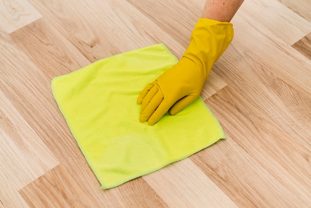 Free Photo | Woman with rubber glove cleaning the floor