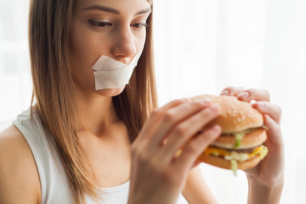 Premium Photo Woman With A Stuck Mouth Tries To Eat Bad Food