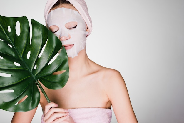 premium-photo-woman-with-a-towel-on-her-head-has-put-a-mask-on-her-face