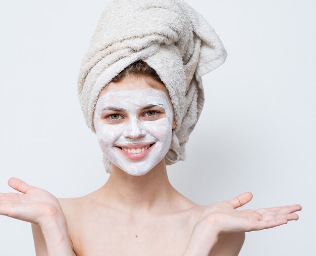 Premium Photo Woman With A White Mask Against Black Dots On Her Face And A Towel On Her Head
