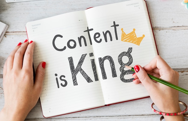 Woman writing content is king on a notebook Premium Photo