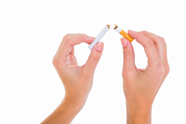 Premium Photo | Womans hands snapping a cigarette