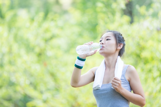 Premium Photo | Women drink water after exercising.