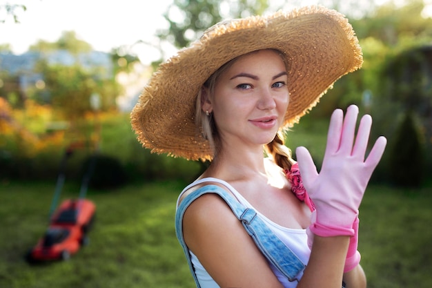 Premium Photo Women Gardener Close Up A Sexy Girl In A Hat Mows The Grass Near The House With