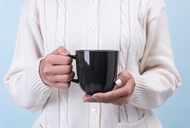 黒セラミックコーヒーカップを持つ女性の手 創造的な広告テキストメッセージまたはプロモーションコンテンツのモックアップ プレミアム写真