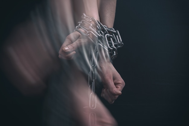 Women hands chained, break out in motion Premium Photo